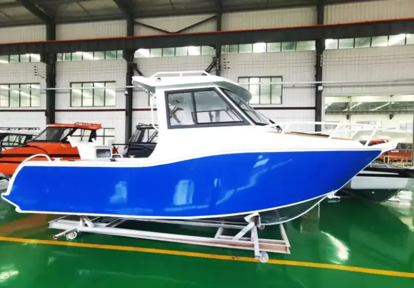 A boat is parked in the middle of an indoor hangar.